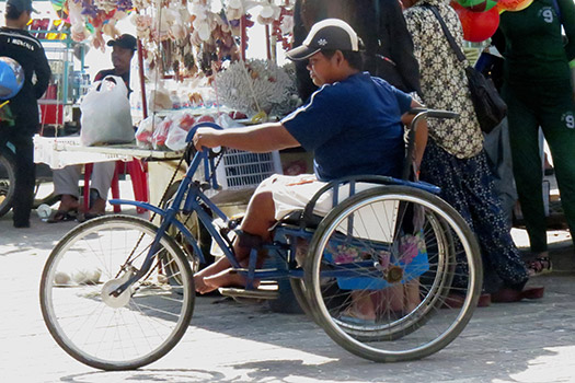 [Photo: Man in Wheelchair]
